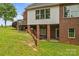 Basement view highlighting the walkout access, brickwork, and outdoor living space at 1825 Smyre Farm Rd, Newton, NC 28658