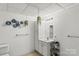 Minimalist bathroom with vanity, mirror, tiled floor, and decorative wall hangings at 1825 Smyre Farm Rd, Newton, NC 28658