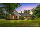 Inviting brick home with manicured lawn, lush landscaping and charming curb appeal with mature trees at 1825 Smyre Farm Rd, Newton, NC 28658