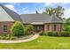 Charming brick home featuring a beautifully landscaped walkway leading to the welcoming front entrance at 1825 Smyre Farm Rd, Newton, NC 28658