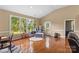 Sunlit living room boasts hardwood floors, large windows offering backyard views, and a cozy seating area at 1825 Smyre Farm Rd, Newton, NC 28658