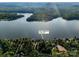 Aerial view of waterfront property with a private dock and lush landscaping at 204 Ridge Dr # 12 12-1 12-2, Troy, NC 27371