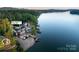 Aerial view of a waterfront estate with a boat dock and swimming pool on a serene lake at 204 Ridge Dr # 12 12-1 12-2, Troy, NC 27371