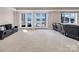 Large finished basement with lake views, plush carpeting, and comfortable seating at 204 Ridge Dr # 12 12-1 12-2, Troy, NC 27371