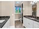 Bright bathroom with marble countertops, a black door, and tile flooring at 204 Ridge Dr # 12 12-1 12-2, Troy, NC 27371