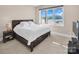 Bedroom with scenic views, featuring a rustic wooden bed frame and bedside table at 204 Ridge Dr # 12 12-1 12-2, Troy, NC 27371