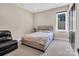 Cozy bedroom with neutral tones, comfortable bed, and a dark accent door at 204 Ridge Dr # 12 12-1 12-2, Troy, NC 27371