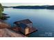 Private boat dock with covered boat slip and sundeck offering direct access to the serene lake at 204 Ridge Dr # 12 12-1 12-2, Troy, NC 27371