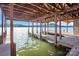 Wooden boathouse and dock on a tranquil lake, offering direct water access at 204 Ridge Dr # 12 12-1 12-2, Troy, NC 27371