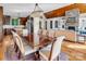 Open-concept living with dining area showcasing a wooden table set, stone fireplace, and hardwood floors at 204 Ridge Dr # 12 12-1 12-2, Troy, NC 27371