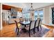 Dining room featuring a waterfront view, stone fireplace, and chandelier lighting fixture at 204 Ridge Dr # 12 12-1 12-2, Troy, NC 27371