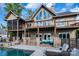 Beautiful outdoor living space with a pool, stone patio, and comfortable lounge seating. For sale canopy 2025 at 204 Ridge Dr # 12 12-1 12-2, Troy, NC 27371