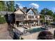 Expansive backyard with a pool, patio, and beautifully landscaped grounds, perfect for entertaining. For sale canopy 2025 at 204 Ridge Dr # 12 12-1 12-2, Troy, NC 27371