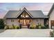 Well-maintained home exterior featuring a prominent front entrance, landscaped garden, and ample parking space at 204 Ridge Dr # 12 12-1 12-2, Troy, NC 27371