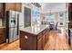 Open kitchen featuring large island, stainless steel refrigerator, and views of the lake and dining area at 204 Ridge Dr # 12 12-1 12-2, Troy, NC 27371