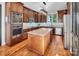 Stylish kitchen featuring wooden cabinets, stainless steel appliances, and a center island for meal preparation at 204 Ridge Dr # 12 12-1 12-2, Troy, NC 27371