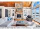 Inviting living room with stone fireplace, built-in shelving, and beautiful lake views at 204 Ridge Dr # 12 12-1 12-2, Troy, NC 27371