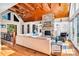 Open living room featuring stone fireplace, wood floors, vaulted ceiling, and access to the outdoors at 204 Ridge Dr # 12 12-1 12-2, Troy, NC 27371