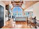 Spacious living room with vaulted ceilings, stone fireplace, hardwood floors, and lake views through large windows at 204 Ridge Dr # 12 12-1 12-2, Troy, NC 27371