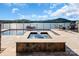 Inviting hot tub overlooks a serene lake view with an expansive paver deck, perfect for relaxation and entertainment at 204 Ridge Dr # 12 12-1 12-2, Troy, NC 27371