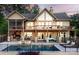 Expansive rear exterior featuring a pool, patio with firepit, covered decks, and stone pillar supports at 204 Ridge Dr # 12 12-1 12-2, Troy, NC 27371