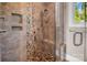 Modern shower featuring river rock tile, a built-in bench, and glass door at 204 Ridge Dr # 12 12-1 12-2, Troy, NC 27371