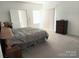 Inviting bedroom featuring a comfortable bed, dresser, and soft, neutral carpeting at 2061 Argentum Ave # 98, Fort Mill, SC 29707