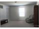Neutral bedroom with chair, side table, plush carpet, and natural light offers a serene retreat at 2061 Argentum Ave # 98, Fort Mill, SC 29707