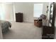 Relaxing bedroom with comfortable bed, dresser, sitting chair and soft carpeting at 2061 Argentum Ave # 98, Fort Mill, SC 29707