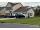 Charming two-story home with red shutters, attached garages and well-maintained lawn at 2061 Argentum Ave # 98, Fort Mill, SC 29707