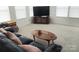 Spacious living room featuring neutral carpet, a dark sofa, and a wood entertainment center at 2061 Argentum Ave # 98, Fort Mill, SC 29707