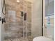 Sleek bathroom shower with stone tile and glass door at 2200 Capes Cove Dr, Sherrills Ford, NC 28673