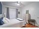 Bright bedroom with hardwood floors, neutral walls, and a large window with patterned curtains at 2200 Capes Cove Dr, Sherrills Ford, NC 28673