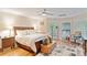 Comfortable bedroom featuring a large bed, wood floors, ample natural light, and charming vintage decor at 2200 Capes Cove Dr, Sherrills Ford, NC 28673
