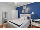 Comfortable bedroom featuring hardwood floors and a blue accent wall at 2200 Capes Cove Dr, Sherrills Ford, NC 28673