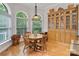 Cozy breakfast nook with natural light, built-in hutch, and hardwood floors at 2200 Capes Cove Dr, Sherrills Ford, NC 28673