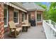 Inviting brick patio features a grilling area, awning, and comfortable seating, perfect for outdoor relaxation and entertaining at 2200 Capes Cove Dr, Sherrills Ford, NC 28673