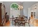 Formal dining room showcasing an elegant chandelier, large window, and beautiful hardwood floors at 2200 Capes Cove Dr, Sherrills Ford, NC 28673