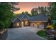 Stunning brick home with a three-car garage and a circular driveway at dusk at 2200 Capes Cove Dr, Sherrills Ford, NC 28673