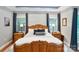 Serene main bedroom with decorative tray ceiling, natural light, and well-appointed furnishings at 2200 Capes Cove Dr, Sherrills Ford, NC 28673