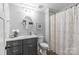 Bathroom featuring a vanity with white countertop, toilet, shower with curtain, and neutral colors at 2414 Bay St, Charlotte, NC 28205