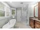 Bright bathroom featuring a soaking tub, walk-in shower, granite vanity, and black and white tile flooring at 2414 Bay St, Charlotte, NC 28205