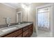 Well-lit bathroom with double vanity, granite countertops, and shower with butterfly curtain at 2414 Bay St, Charlotte, NC 28205
