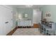 Light bedroom with a white dresser, grey desk, and hardwood floors and is filled with natural light at 2414 Bay St, Charlotte, NC 28205