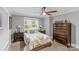Bedroom with a ceiling fan, a large window, and a large dresser provides a relaxing personal space at 2414 Bay St, Charlotte, NC 28205