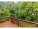 Wooden deck with lush green lawn, mature trees, and play structure in the backyard at 2414 Bay St, Charlotte, NC 28205