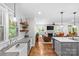 Bright, open-concept kitchen and living area featuring hardwood floors and updated appliances at 2414 Bay St, Charlotte, NC 28205