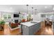 Open-concept living area with kitchen island, fireplace, hardwood floors, and comfortable seating at 2414 Bay St, Charlotte, NC 28205