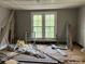 Bedroom awaiting renovation, featuring natural light from the windows at 273 E Main Ave, Taylorsville, NC 28681