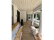 Spacious front porch with wood decking and decorative columns, perfect for relaxing outdoors at 273 E Main Ave, Taylorsville, NC 28681